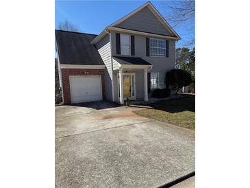 Charming two-story home with attached garage and well-maintained front yard at 5891 Raven Ln, Lithonia, GA 30058