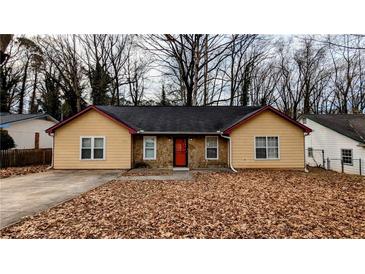 Charming single-story home with a well-maintained lawn and stone accents at 1343 Willow Sw Trl, Atlanta, GA 30311