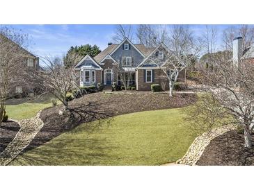 Charming two-story home features a landscaped front yard, brick accents, and a welcoming entrance at 3825 Bishops Walk, Cumming, GA 30041