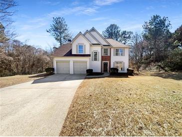 Charming two-story home with a well-manicured lawn, a two-car garage, and classic architectural design at 1740 Berry Ct, Cumming, GA 30041