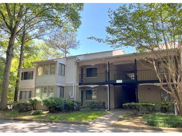 A charming condo with traditional architecture and a covered entry, surrounded by mature trees and landscaping at 3020 Wingate Way, Sandy Springs, GA 30350