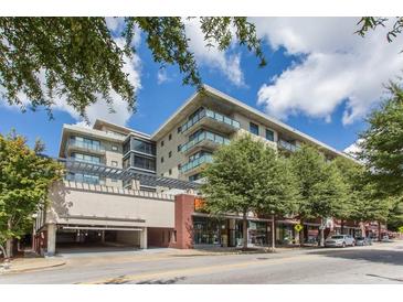 Modern condo building featuring a sleek design with balconies, street-level retail, and an open parking garage at 335 W Ponce De Leon Ave # 506, Decatur, GA 30030