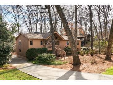 Charming home featuring a combination of stone and wood facade, with a wooden porch and well-manicured landscaping at 3640 Shelby Ln, Marietta, GA 30062