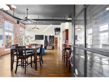 Spacious open living room featuring exposed brick walls, hardwood floors, and modern lighting at 1459 Village Park Ct, Atlanta, GA 30319