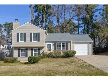 Charming two-story home with a well-maintained front yard and attached garage at 1614 Carrie Farm Ct, Kennesaw, GA 30144
