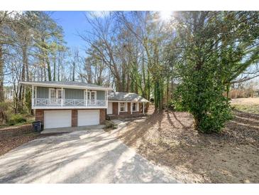 Charming home with two-car garage and a cozy balcony overlooking the landscaped front yard at 772 Verde Dr, Riverdale, GA 30274