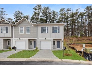 Charming townhome showcasing a two-story design with attached garage and manicured front lawn at 9458 Cedar Grove Ct # 330, Jonesboro, GA 30238