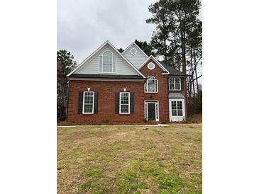 Charming brick home featuring a mix of classic and modern architectural design elements at 6910 Stone Breeze Dr, Stone Mountain, GA 30087