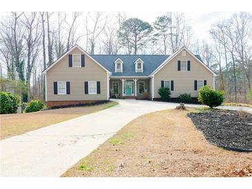 Charming single Gathering home with a neatly manicured lawn and inviting curb appeal at 814 Oak Moss Dr, Lawrenceville, GA 30043