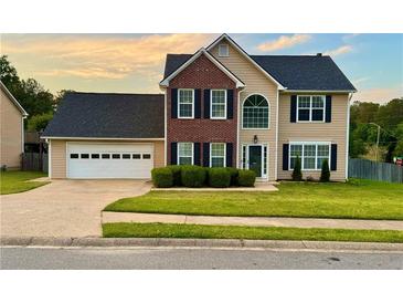 Charming two-story home featuring a brick accent, attached garage, and well-manicured lawn at 2586 Abbotts Glen Dr, Acworth, GA 30101