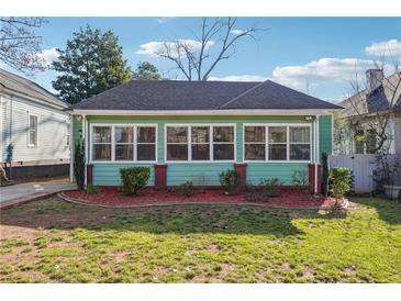 Charming single-story home featuring light green siding, white trim, and a well-manicured front yard at 1474 Athens Avenue Sw Ave, Atlanta, GA 30310