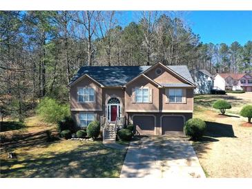 Charming two-story home with well-maintained lawn, mature trees, and a two-car garage at 1630 Versailles Dr, Atlanta, GA 30331