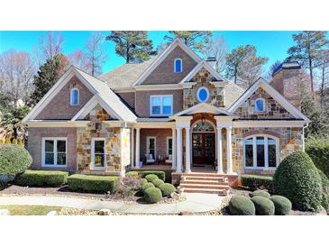 Beautiful brick home featuring a stone facade, manicured landscaping, and a welcoming front entrance at 2892 Darlington Run, Duluth, GA 30097