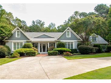Charming single-story home featuring well-manicured landscaping and a spacious concrete driveway at 3045 Camp Branch Rd, Buford, GA 30519