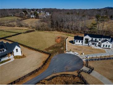 Stunning aerial view of a modern home with expansive yard and beautiful landscaping at 5170 Howard Road A, Cumming, GA 30040