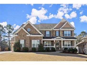 Charming brick home with a welcoming front porch and manicured lawn at 170 Wheaten Dr, Woodstock, GA 30188
