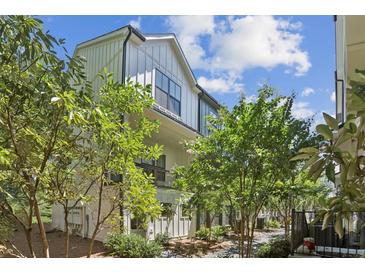 Modern farmhouse exterior with white siding, black trim, and lush landscaping at 321 Dilbeck Ne Cir, Atlanta, GA 30342