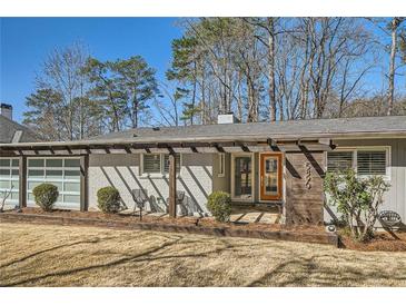 Charming single-story home with a modern exterior and inviting front entrance and a well-manicured lawn at 5890 Kayron Dr, Atlanta, GA 30328