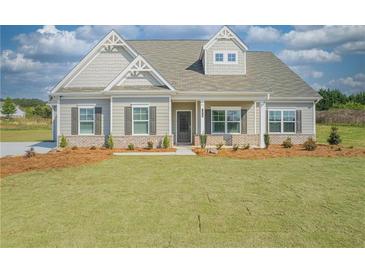Charming single-story home featuring a well-manicured lawn and traditional architectural details at 1471 Stephens View Dr, Loganville, GA 30052