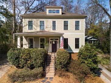 Charming two-story home with a covered front porch and well-manicured landscaping at 1828 Almeta Ne Ave, Atlanta, GA 30307