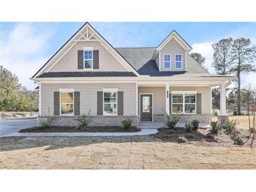 Charming single-Gathering home features a welcoming front porch, gray siding, and beautifully trimmed windows at 1461 Stephens View Dr, Loganville, GA 30052