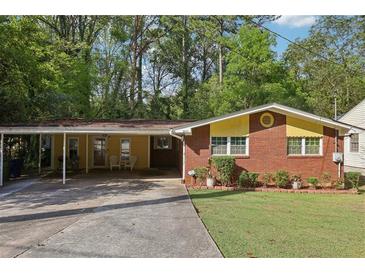Charming brick home featuring a covered carport and a well-manicured lawn at 2081 Beecher Sw Rd, Atlanta, GA 30311