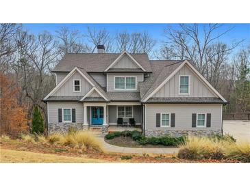 Charming two-story home with stone accents and a welcoming blue front door at 325 William Falls Dr, Canton, GA 30114