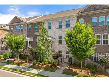 Charming townhomes with brick facades, complemented by manicured landscaping and small trees at 3538 Davenport Rd, Duluth, GA 30096