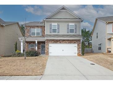 Charming two-story home with stone accents, gray siding, and a two-car garage at 981 Sonoma Dr, Lawrenceville, GA 30045