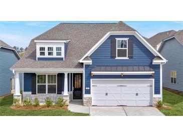 Charming blue home featuring stone accents, a two-car garage, and a welcoming front porch at 53 Colonial Ter, Villa Rica, GA 30180