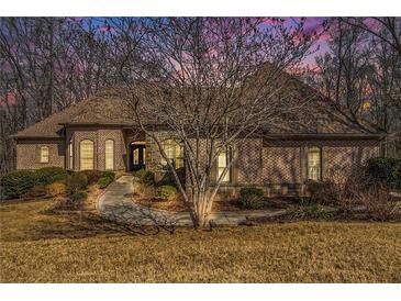 Charming brick home featuring a well-manicured lawn and an inviting entrance walkway at 490 Revenna Trl, Fayetteville, GA 30214