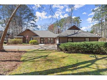 Charming single-story home with well-maintained landscaping, large driveway, and classic design elements at 3093 Brookshire Way, Duluth, GA 30096