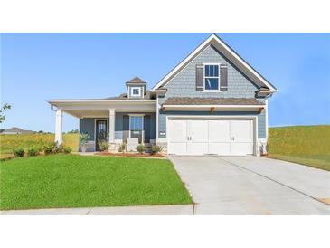 Charming single-Gathering home with blue siding, white garage door, and well-manicured lawn at 47 Colonial Ter, Villa Rica, GA 30180