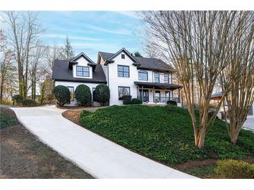 Beautiful two-story home with a well-manicured lawn and a long driveway at 160 Deer Cliff Cv, Lawrenceville, GA 30043