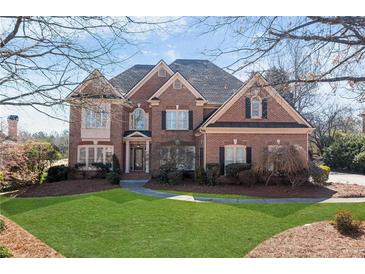 Charming two-story brick home with well-manicured lawn and mature landscaping at 1021 Windermere Xing, Cumming, GA 30041