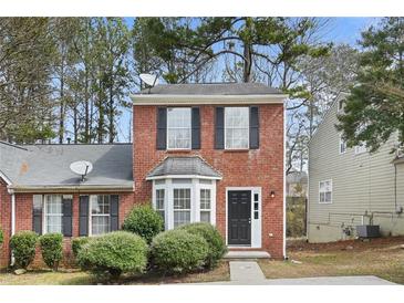 Charming brick two-story home with well-maintained landscaping and black shutters at 3188 Kingswood Gln, Decatur, GA 30034