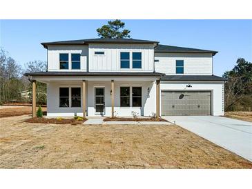 Charming new construction home featuring white brick, two-car garage, and a welcoming front porch at 478 Majestic Oaks Pl, Smyrna, GA 30082