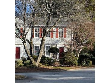 Charming townhome with red shutters, neat landscaping, and inviting curb appeal at 3980 Bayside Cir, Atlanta, GA 30340