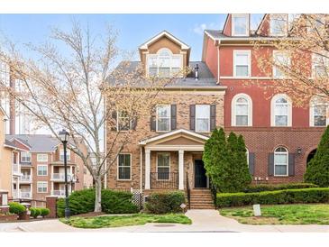 Charming brick townhome featuring a well-manicured front yard and a welcoming entrance at 142 Perimeter Walk, Atlanta, GA 30338