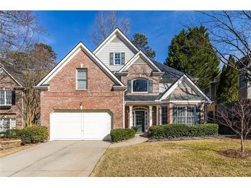 Charming two-story brick home with manicured landscaping and a two-car garage at 1224 Indian Hills Pkwy, Marietta, GA 30062