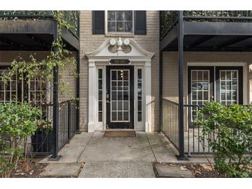 Stylish condo entrance featuring a classic white door with decorative columns and black iron railings at 3529 Essex Ave # 75, Atlanta, GA 30339