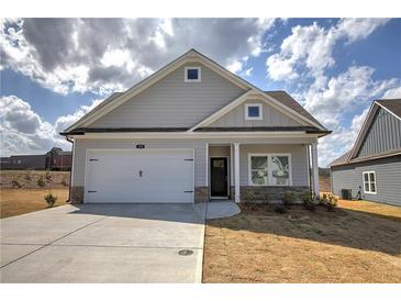 Charming single-Gathering home with a two-car garage, stone accents, and landscaped front yard at 121 Sunflower Cir, Cartersville, GA 30121