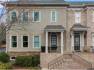 Charming townhome with a neutral stucco facade, brick accents, and a welcoming entrance at 1477 Village Park Ne Ct, Atlanta, GA 30319