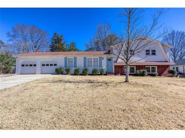 Charming two-story home features a two-car garage and inviting curb appeal at 1722 Johnston Nw Trl, Kennesaw, GA 30152