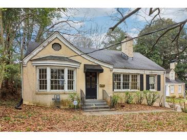 Charming, one-story brick home with bay window, chimney, black shutters and an inviting front entrance at 1815 Monroe Ne Dr, Atlanta, GA 30324