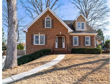 Charming brick home with a manicured lawn, walkway, and a classic architectural design at 2385 Cape Courage Way, Suwanee, GA 30024