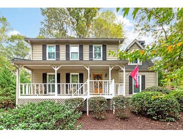 Charming two-story home with a welcoming front porch and meticulously maintained landscaping at 4160 Westchester Ne Xing, Roswell, GA 30075