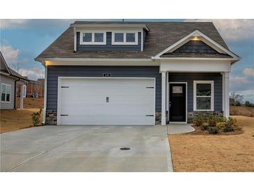 Charming two-story home with blue siding, white garage door, and stone accents at 201 Daisy Coourt, Cartersville, GA 30121