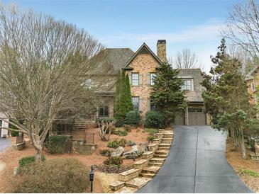 Charming brick two-story home with mature landscaping and a paved driveway at 415 Prestwick Ct, Alpharetta, GA 30005