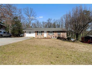 Charming brick home featuring a well-maintained front yard and a welcoming entrance at 147 Windy Hill Sw Rd, Marietta, GA 30060
